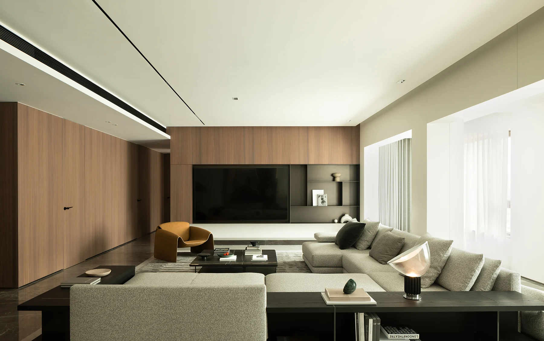 Finished living room with wood-grain TV wall and integrated storage